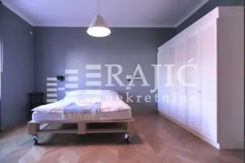 Modern bedroom with a double bed and a large white wardrobe. - image 3