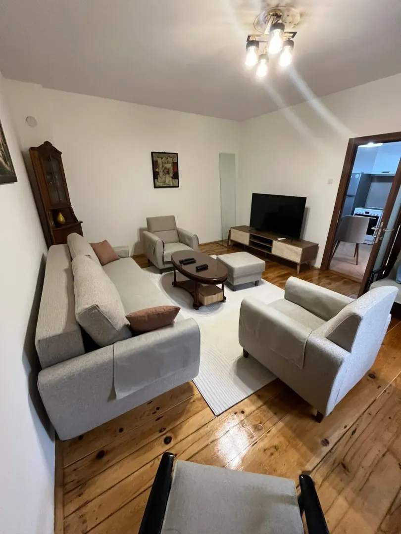 Living room with sofa set, coffee table and television.