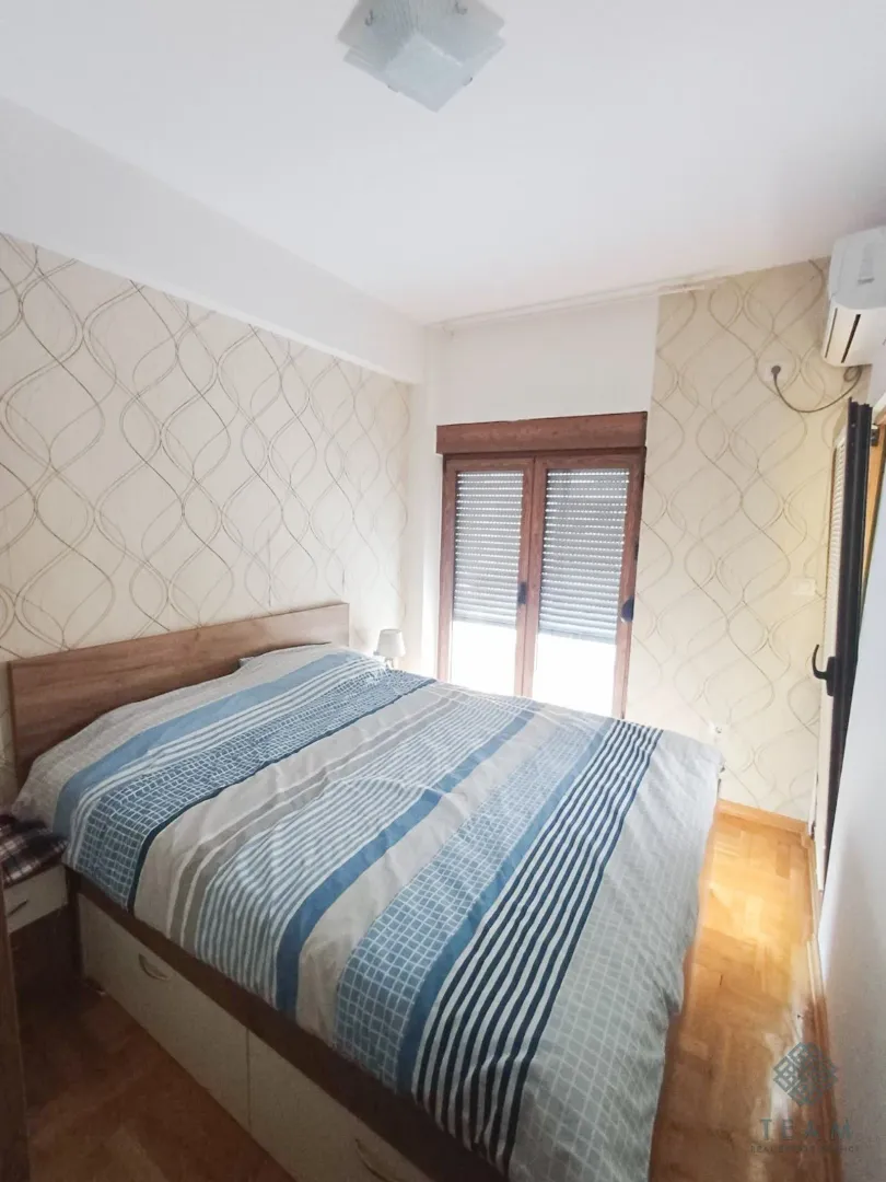 Bedroom with a double bed and a window.
