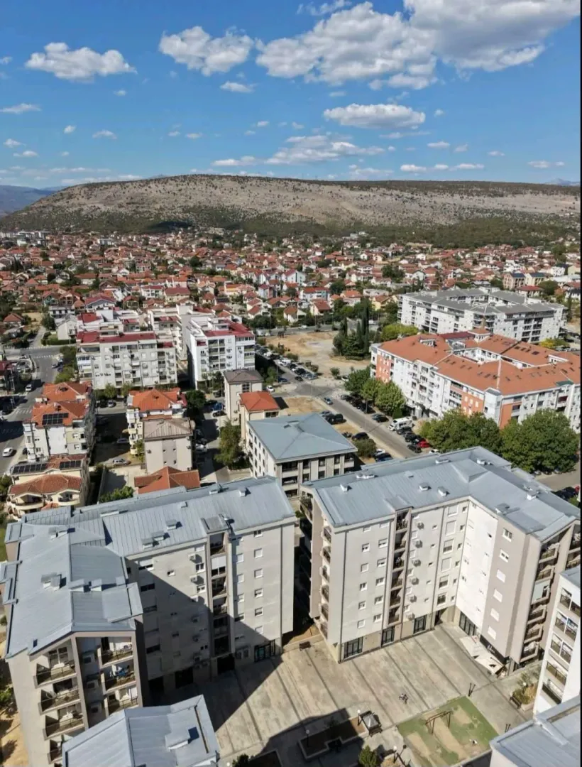 Aerial view of residential buildings and the surrounding neighborhood.