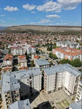 Aerial view of residential buildings and the surrounding neighborhood. - image 10