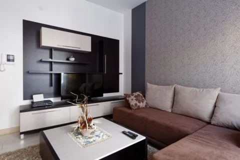 Modern and bright living room with a sofa and TV unit. - image 7