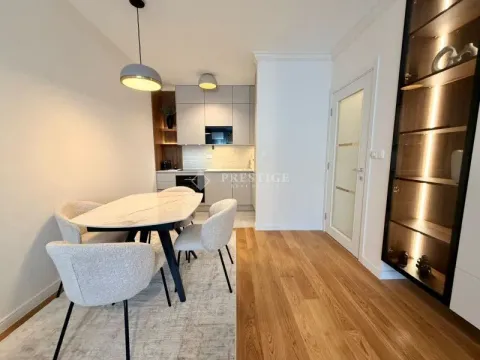 Modern dining area with a dining table and chairs, connected to the kitchen. - image 4