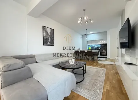 Living room with a sofa set and a dining area in the background. - image 3