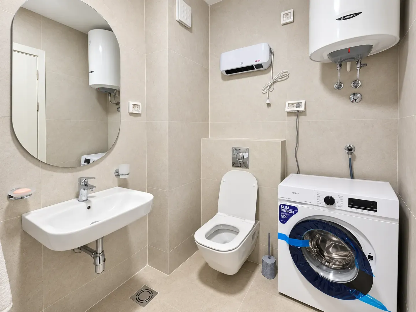 Bathroom equipped with a washbasin, toilet, water heater, and washing machine.
