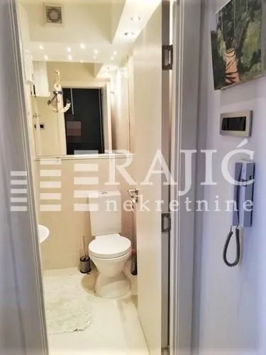 View of a small bathroom with a toilet.