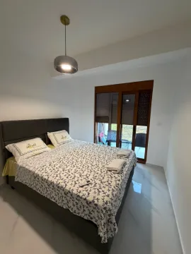 Bright bedroom with a double bed and access to the terrace. - image 2