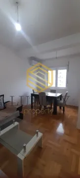 Living room with a dining area and parquet flooring. - image 2