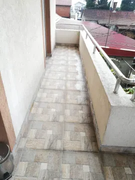 Narrow balcony with tiled floor and metal railing. - image 14