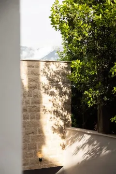 Exterior of the building with a stone facade and courtyard. - image 6