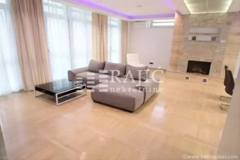 Spacious living room with a sofa, fireplace, and wooden flooring. - image 13