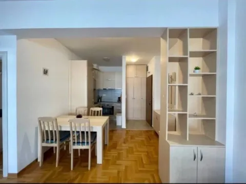 Living room with dining area and view towards the kitchen and hallway. - image 2