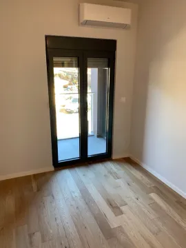 Empty room with wooden flooring, air conditioning and access to the terrace. - image 2