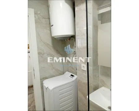 Bathroom with a washing machine, boiler, and washbasin tiled with marble. - image 3
