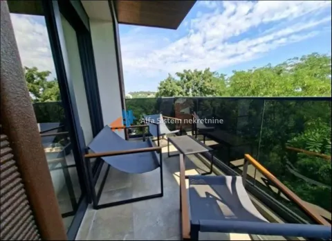 Furnished balcony with seating set and greenery view. - image 2