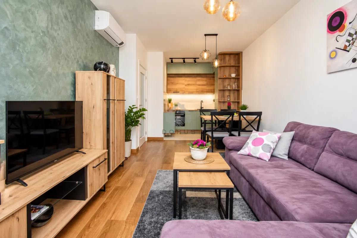 Living room connected to the dining area and kitchen in an open plan.