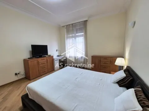 Furnished bedroom with a double bed and wooden dressers. - image 12