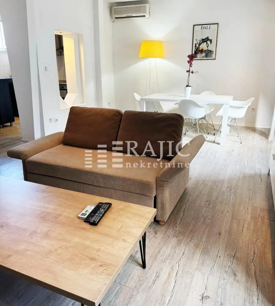 Living room with sofa and dining area.