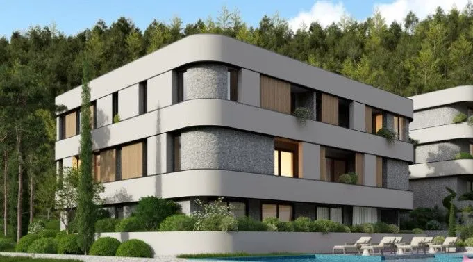 Eksterijer moderne stambene zgrade okružene zelenilom.