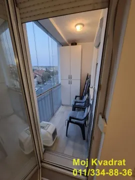 Zastakljena terasa sa stolicama, ormanom i pogledom na okolinu. - image 13