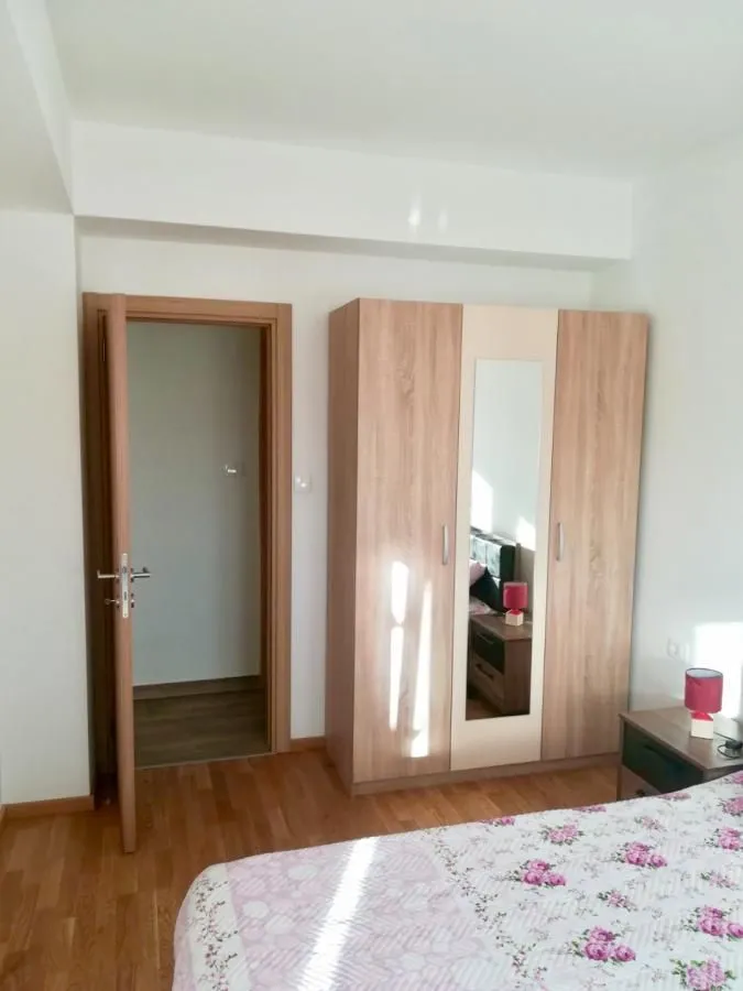 Bedroom with a wooden wardrobe and a bed.