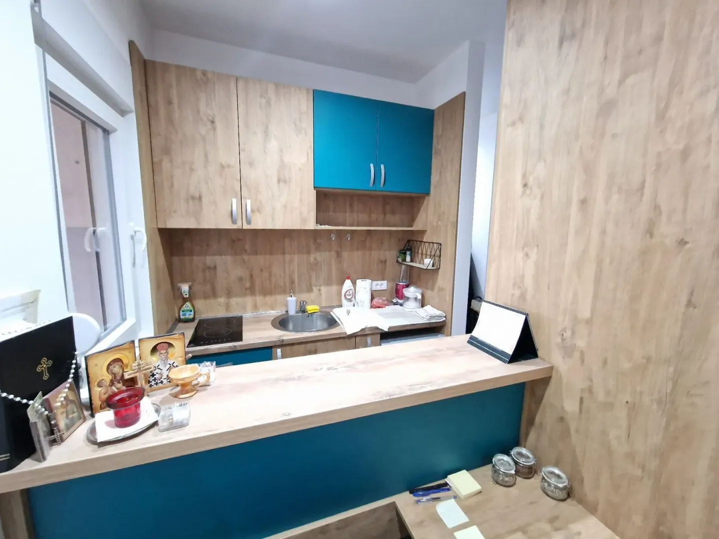 Small kitchen with wooden cabinetry and a breakfast bar.