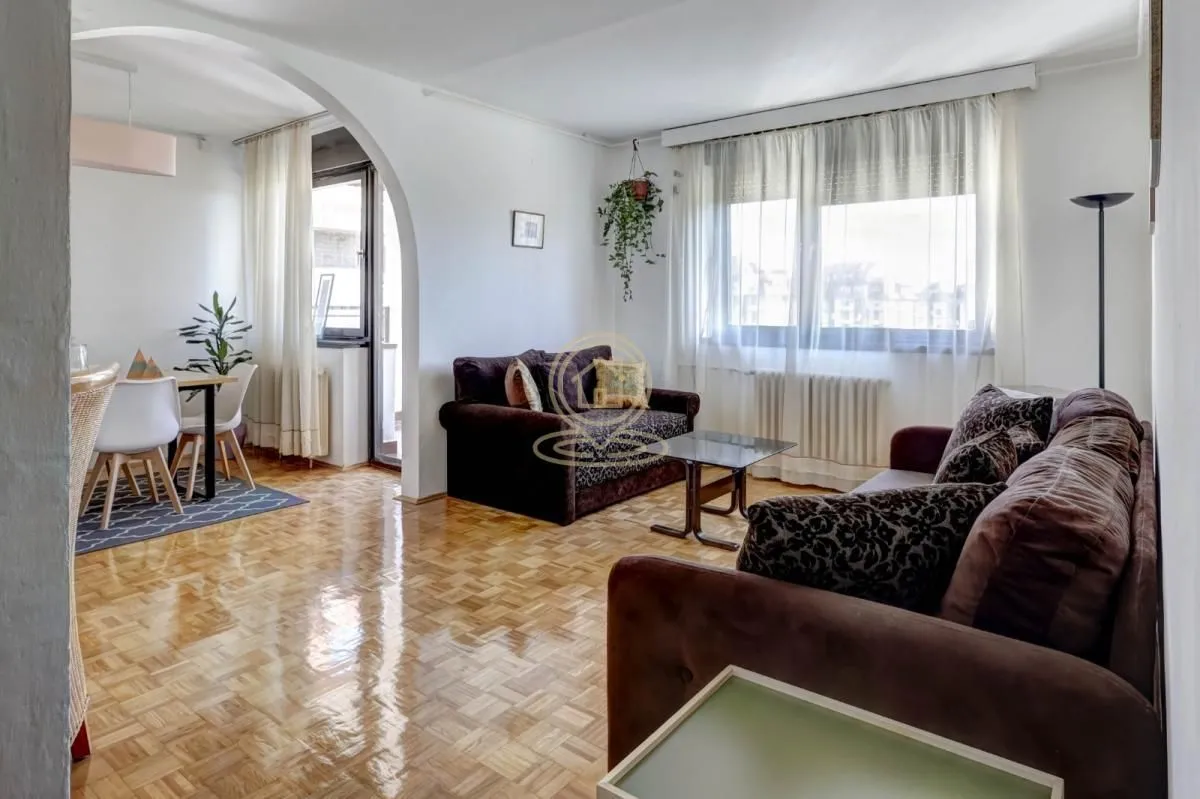 Spacious living room with a sofa set and a view of the dining area.