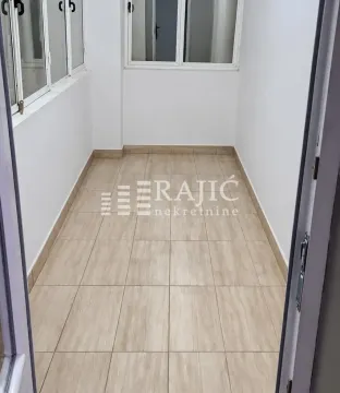 Empty enclosed balcony with ceramic floor tiles. - image 11