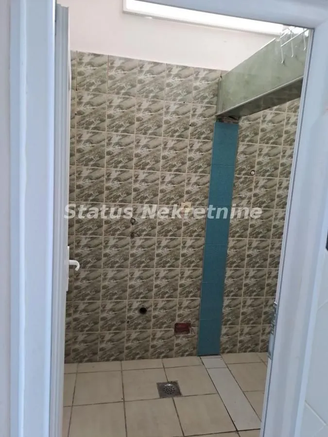 Bathroom under renovation with wall tiles and a floor drain.