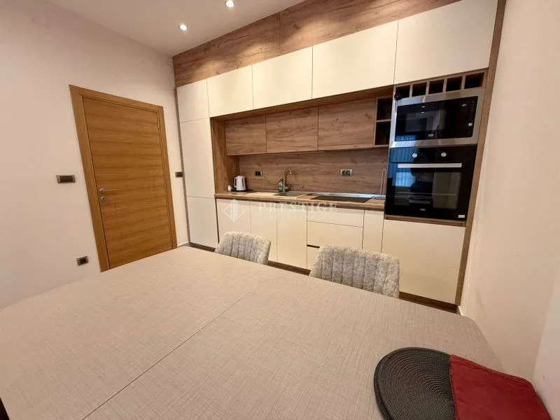 Modern kitchen with a dining table and built-in appliances.