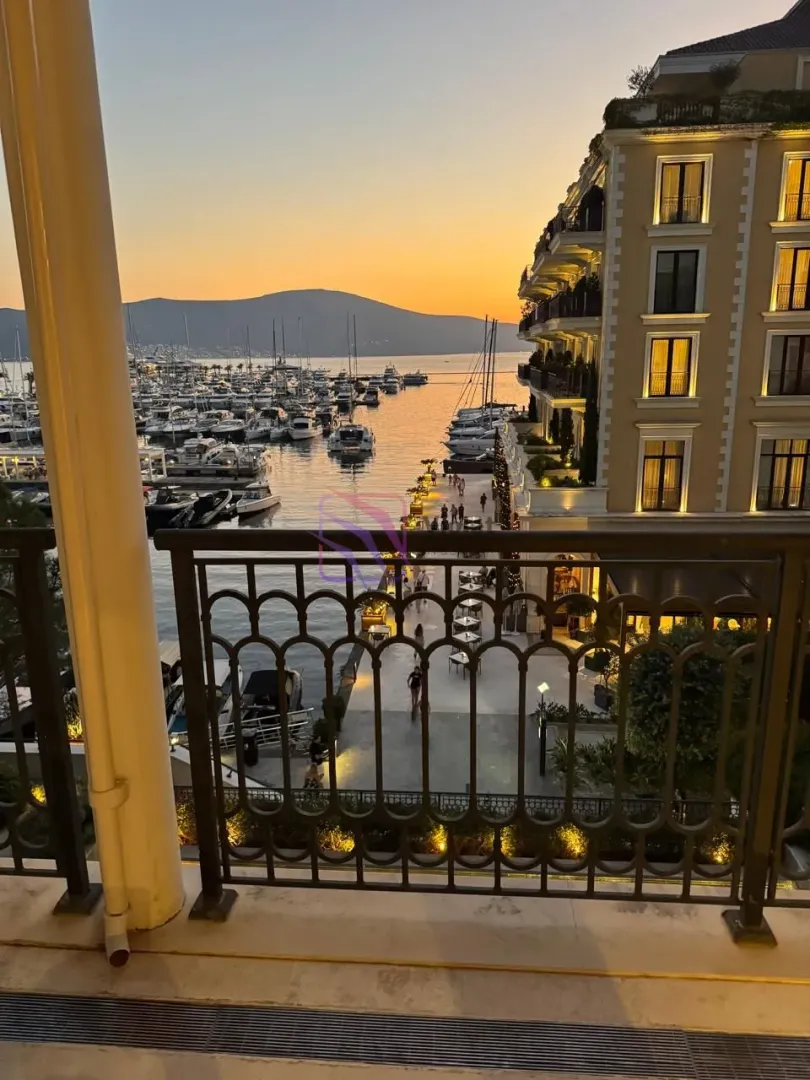 View from the balcony overlooking the marina and bay at dusk.