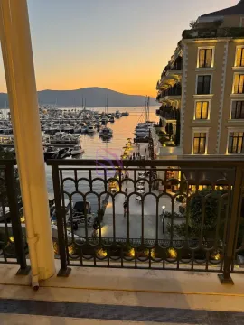 View from the balcony overlooking the marina and bay at dusk. - image 5