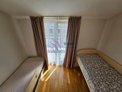 Children's bedroom with two single beds and balcony access. - image 9