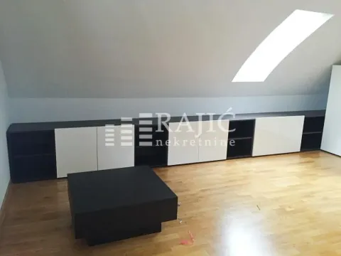 Attic room with built-in closets and a skylight. - image 9