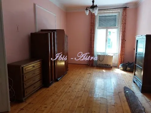 Spacious room with a wooden floor, wooden furniture and a large window. - image 2