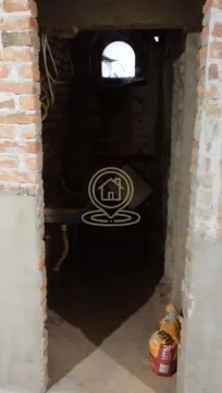 View of a utility room under renovation with a small window and building materials. - image 7