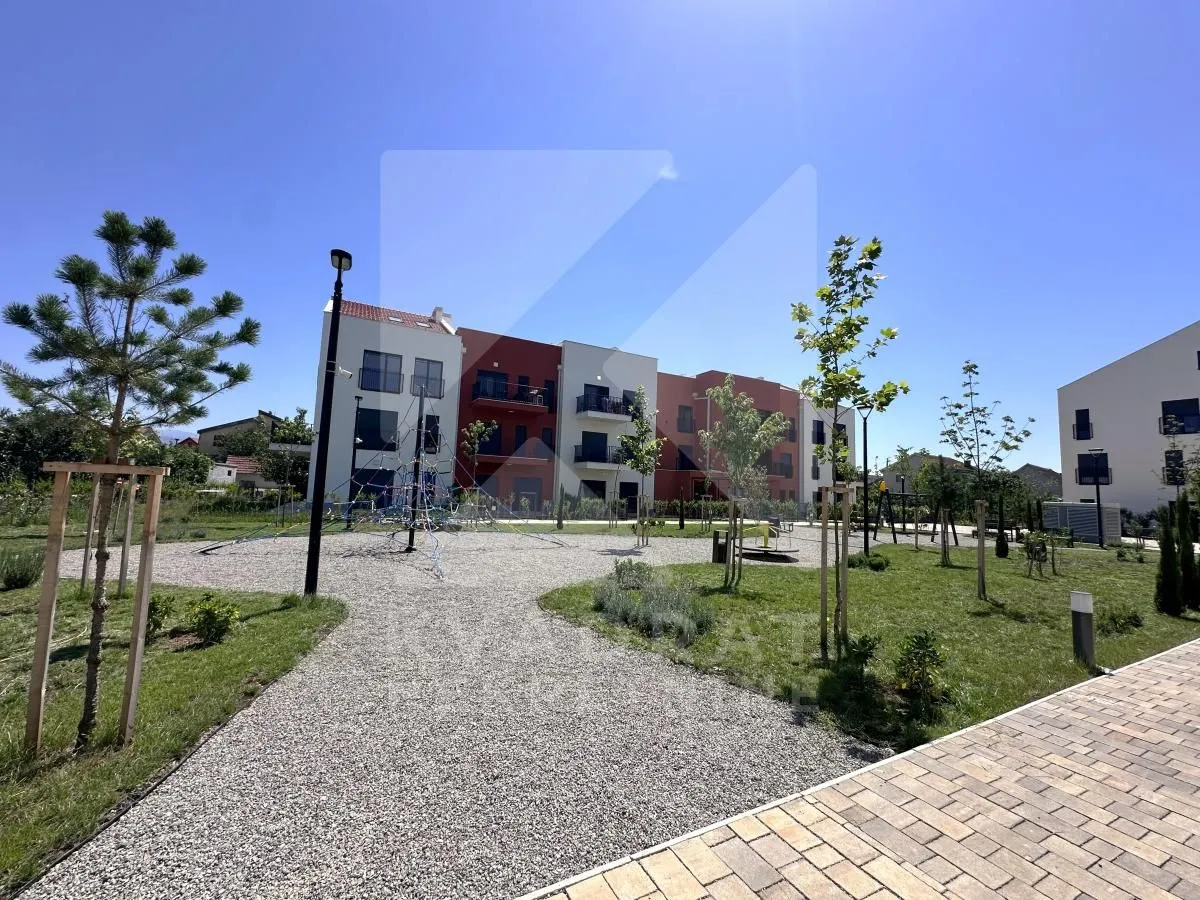 View of the buildings and landscaped courtyard with a children's playground.