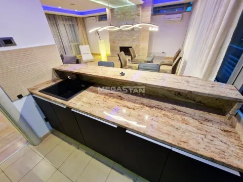 View from the kitchen with a bar counter towards the living room and dining area. - image 9