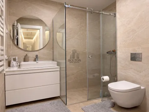 Modernly equipped bathroom with a walk-in shower, washbasin, and toilet. - image 11