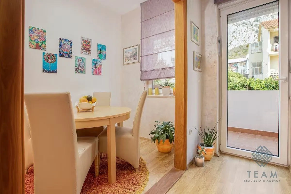 Dining area with a table, chairs, and access to the terrace.