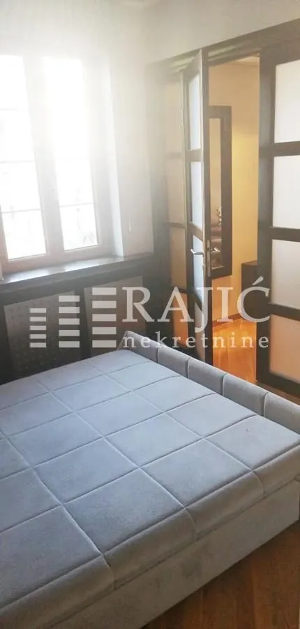 Bedroom with a double bed and a window.