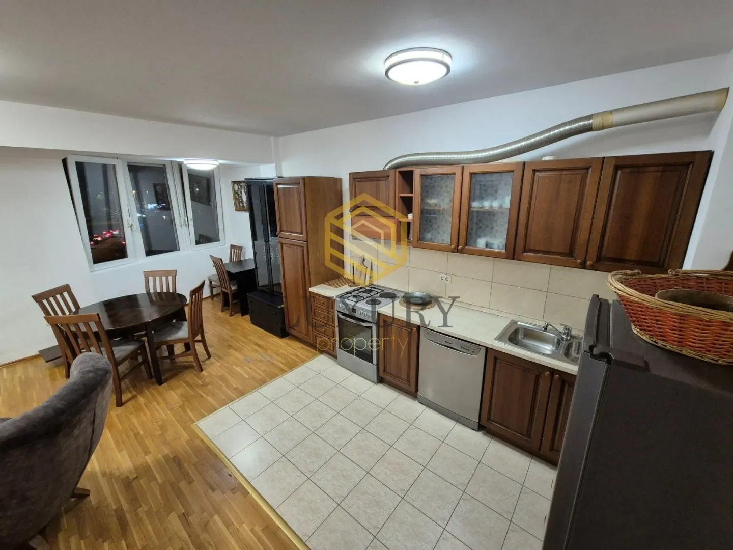 Spacious kitchen with wooden cabinets and a dining table.