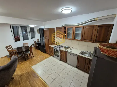 Spacious kitchen with wooden cabinets and a dining table. - image 4
