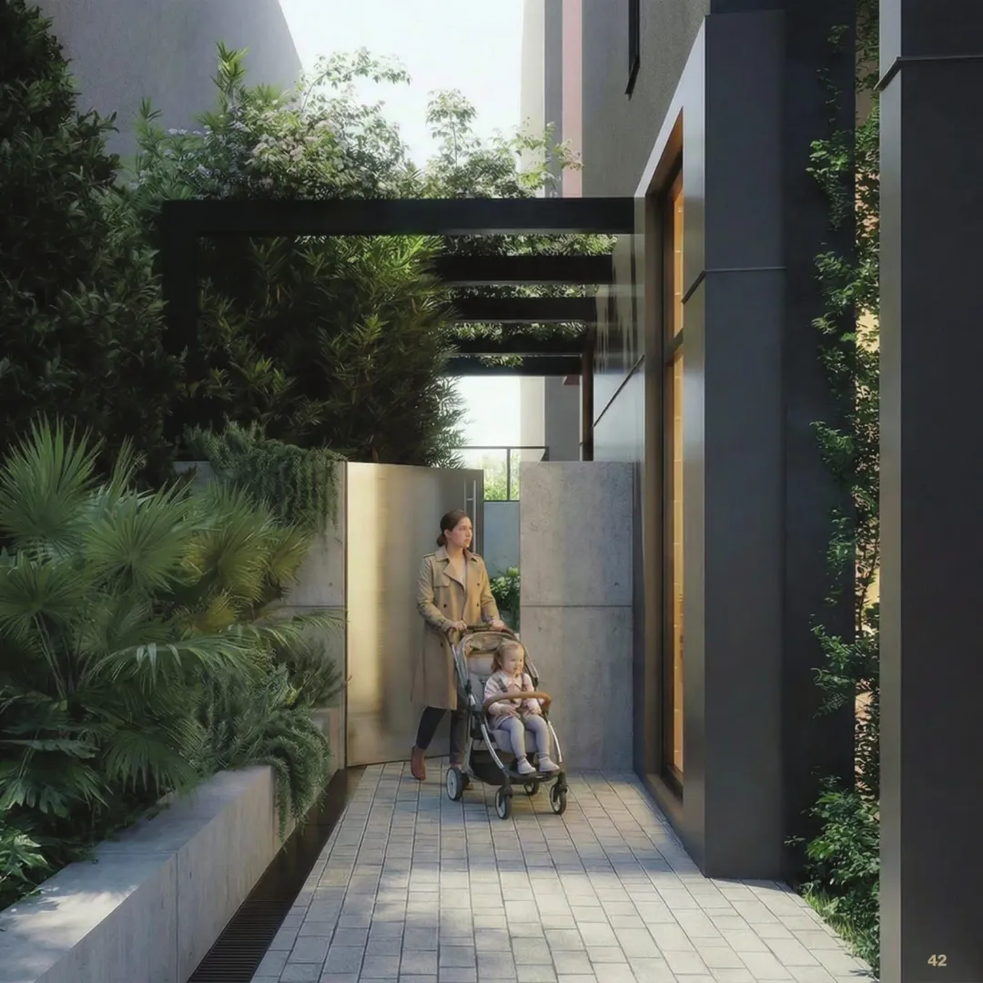 Exterior of the building with a landscaped walkway and greenery.