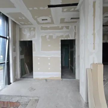 View of the interior of a property under construction with drywall works on the walls. - image 6