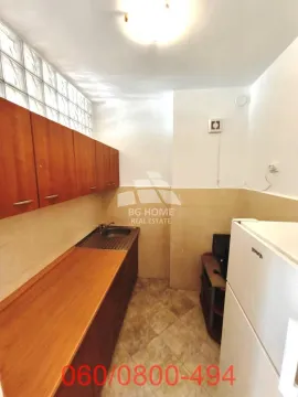 Smaller kitchen with wooden cabinets and a white refrigerator. - image 7