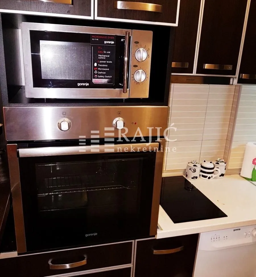 View of the built-in oven, microwave, and kitchen countertop.