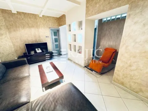 Spacious and furnished living room with a sofa set and television. - image 3