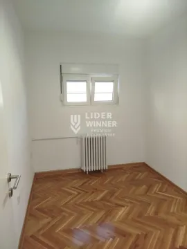 Empty unfurnished room with a window and wooden parquet flooring. - image 14