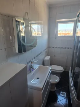 Bathroom equipped with a shower cabin, washbasin, and sanitary fixtures. - image 2